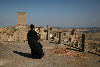 A ghost looks over her ghost town.